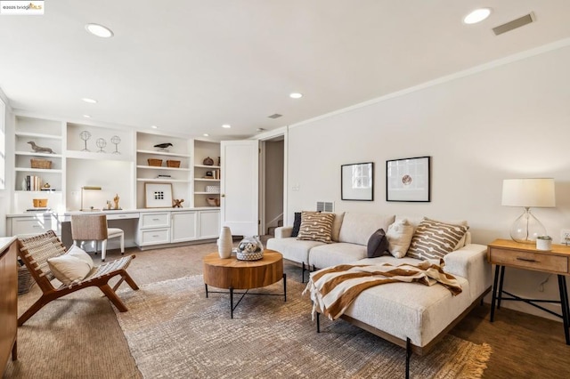 carpeted living room featuring ornamental molding and built in desk