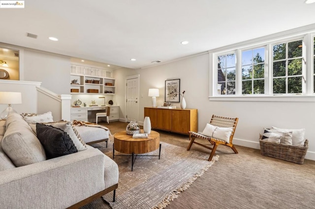 sitting room featuring carpet flooring and built in desk