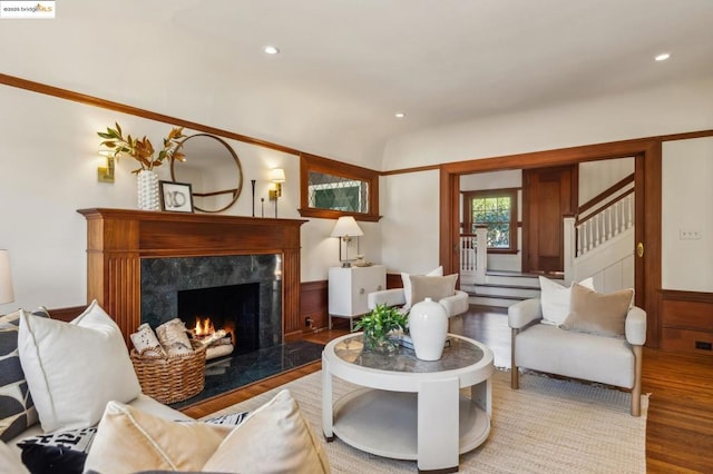 living room with lofted ceiling, hardwood / wood-style floors, and a fireplace