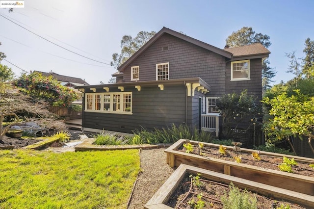 rear view of house featuring a lawn