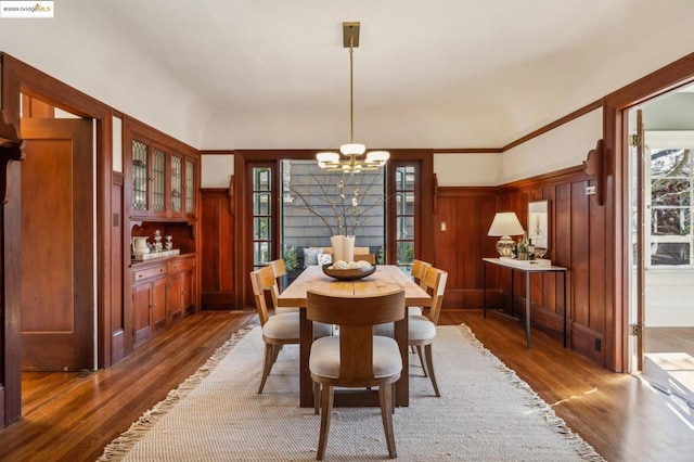 dining area featuring dark hardwood / wood-style flooring and a notable chandelier