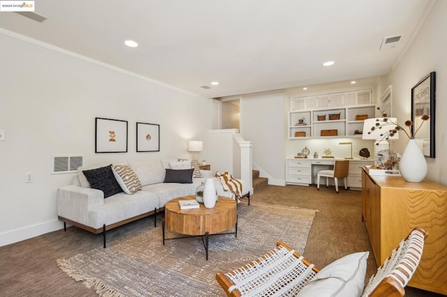 carpeted living room featuring crown molding and built in desk