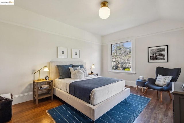 bedroom with dark wood-type flooring