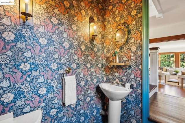 bathroom with hardwood / wood-style flooring and toilet