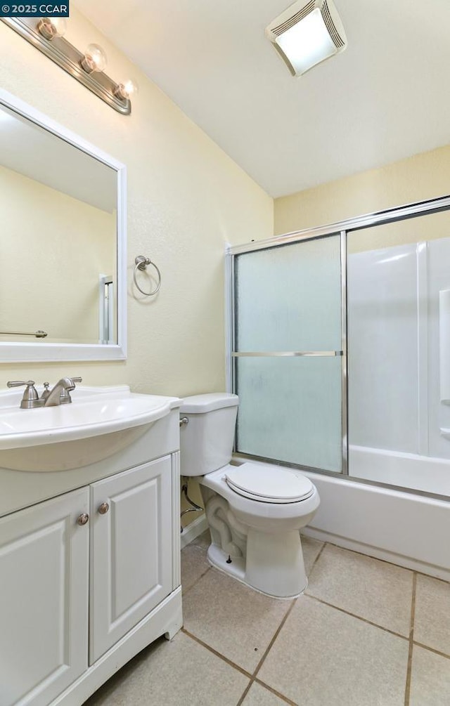 full bathroom featuring tile patterned flooring, vanity, enclosed tub / shower combo, and toilet