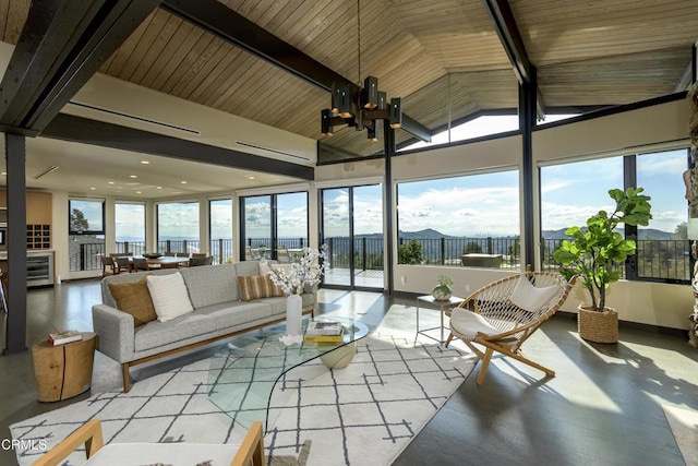 sunroom / solarium featuring vaulted ceiling with beams, plenty of natural light, and a chandelier