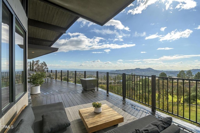 wooden deck featuring a mountain view