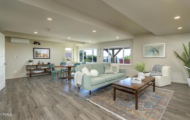 living room featuring an AC wall unit, dark wood-type flooring, and beam ceiling