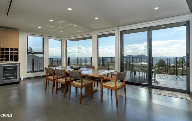 dining space featuring wine cooler and plenty of natural light