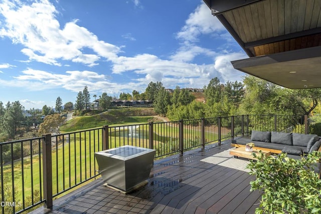 wooden terrace featuring a yard and outdoor lounge area