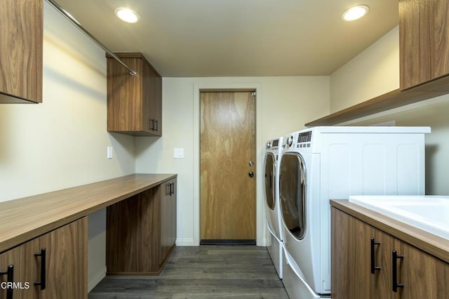 laundry area featuring separate washer and dryer, cabinets, and dark hardwood / wood-style floors