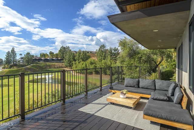 deck featuring outdoor lounge area and a lawn