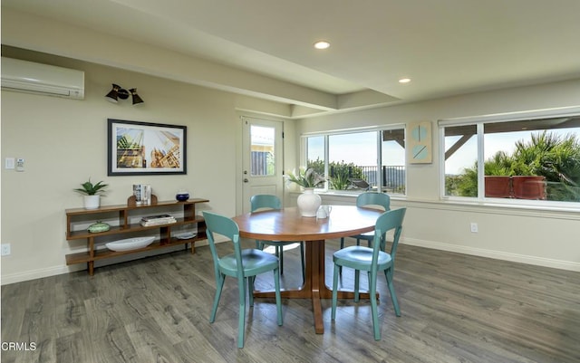 dining area with a wall unit AC and dark hardwood / wood-style floors