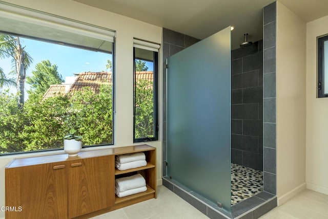 bathroom featuring a tile shower and tile patterned floors