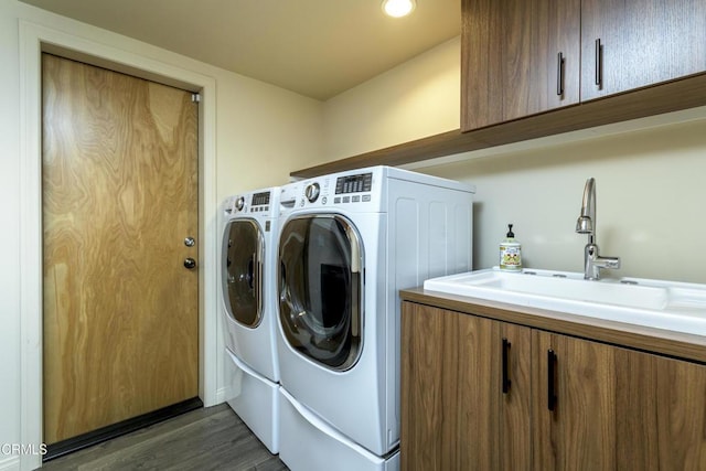 laundry room with cabinets, separate washer and dryer, sink, and dark hardwood / wood-style floors