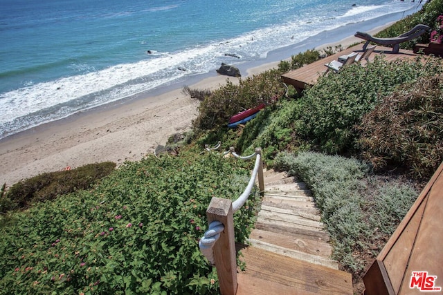 aerial view featuring a water view and a beach view