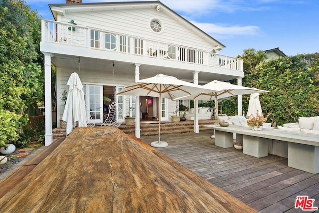 back of house featuring outdoor lounge area