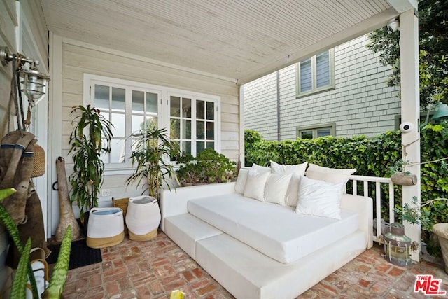 view of patio / terrace with a porch and an outdoor living space