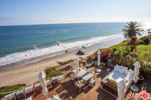 exterior space featuring a beach view and a water view