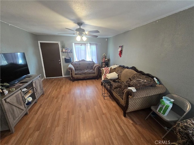 living room featuring hardwood / wood-style floors and ceiling fan