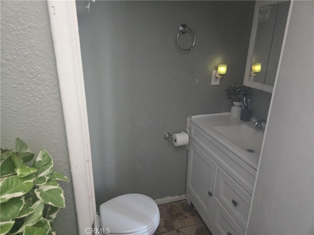 bathroom with tile patterned floors, vanity, and toilet