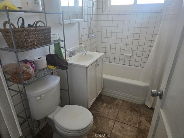 full bathroom featuring vanity, shower / bath combination with curtain, and toilet