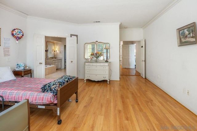 bedroom featuring ornamental molding, connected bathroom, and light hardwood / wood-style flooring