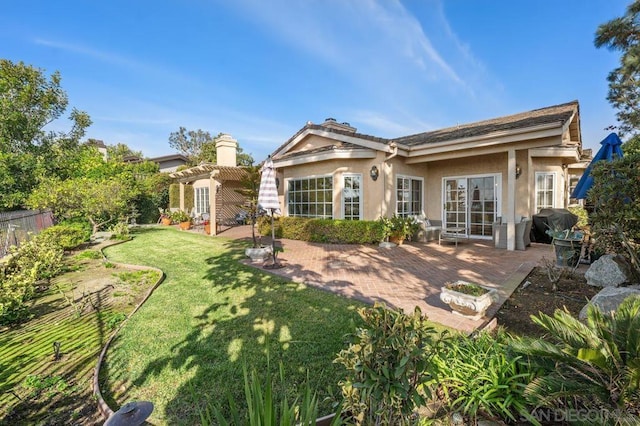 rear view of house with a pergola, a yard, and a patio area