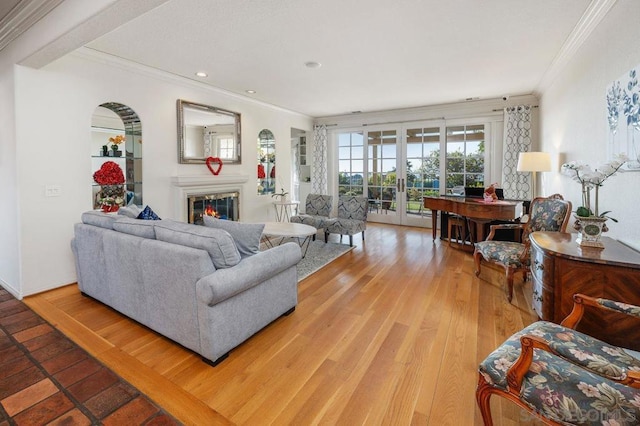 living room featuring ornamental molding, wood-type flooring, and french doors