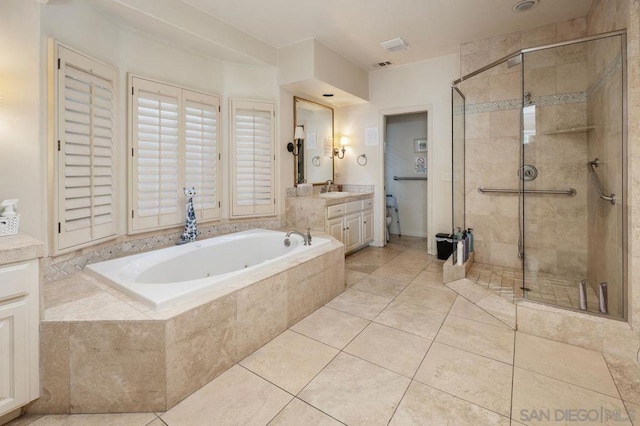 bathroom featuring shower with separate bathtub, vanity, and tile patterned floors