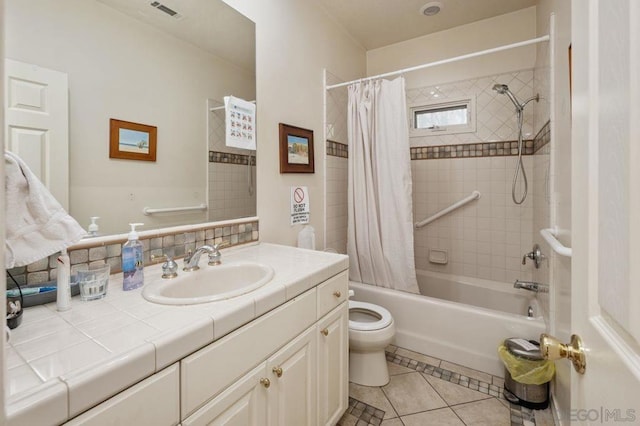 full bathroom with tile patterned floors, toilet, shower / bath combo with shower curtain, and vanity