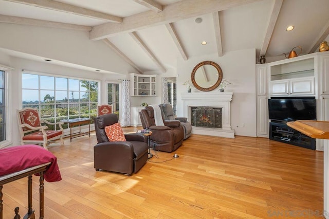 living room featuring lofted ceiling with beams and light wood-type flooring