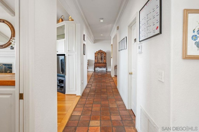 corridor featuring crown molding