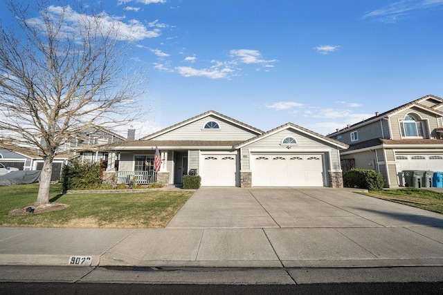 view of front of property featuring a garage, a front lawn, and covered porch