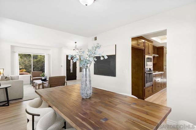 dining space with light wood-type flooring