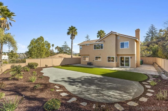 rear view of property with central AC and a patio area