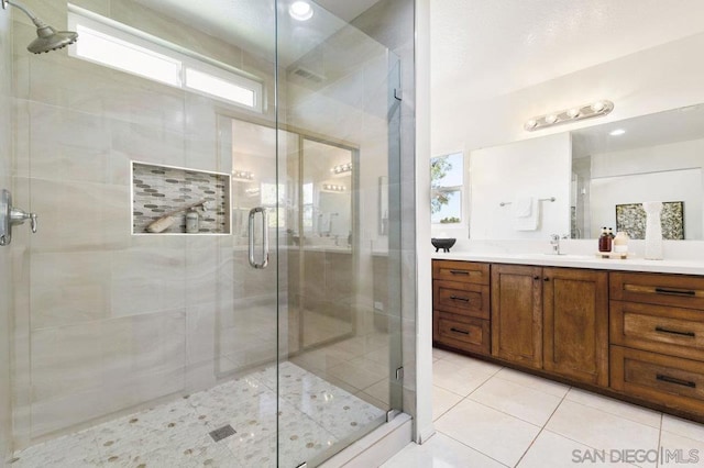 bathroom with vanity, tile patterned flooring, and a shower with shower door