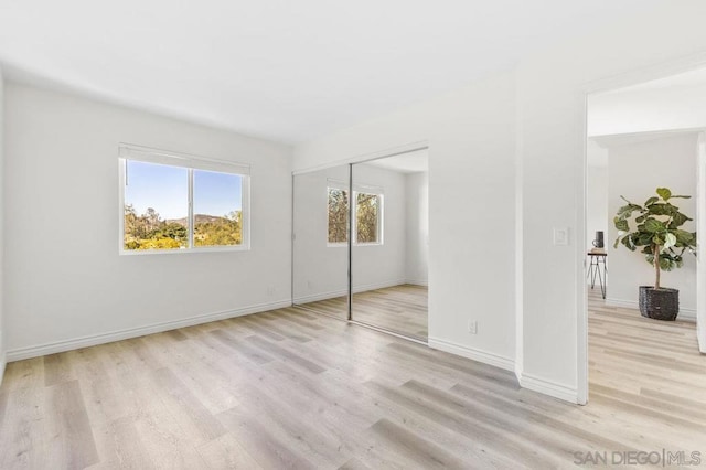 unfurnished bedroom featuring a closet and light wood-type flooring