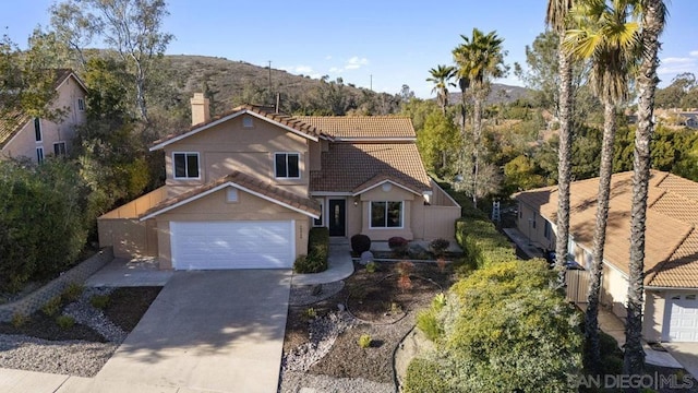 view of property featuring a garage and a mountain view