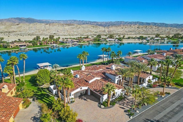 drone / aerial view with a water and mountain view