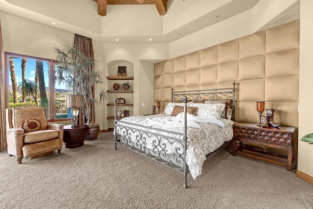 carpeted bedroom featuring a high ceiling