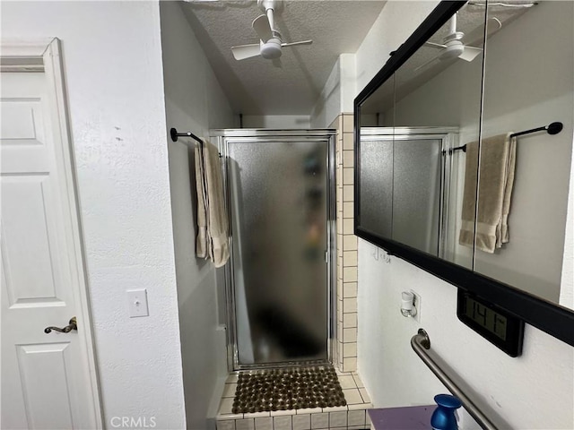 bathroom featuring a shower with door, ceiling fan, tile patterned floors, and a textured ceiling