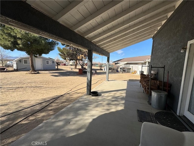 view of patio with an outbuilding