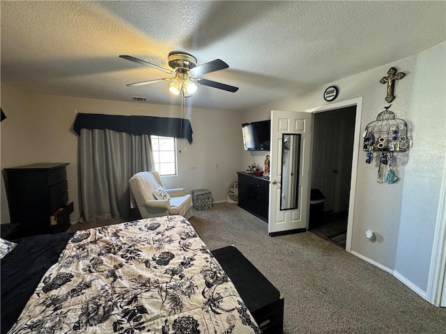 carpeted bedroom with ceiling fan and a textured ceiling