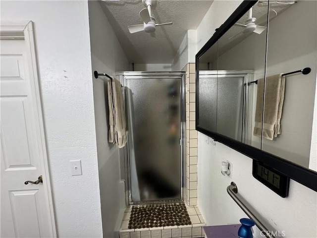 bathroom featuring walk in shower, ceiling fan, tile patterned flooring, and a textured ceiling