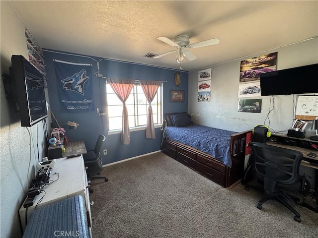 carpeted bedroom with ceiling fan and a textured ceiling