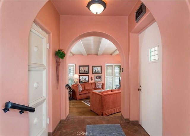 hallway with a wealth of natural light and beam ceiling