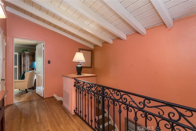 corridor featuring vaulted ceiling with beams, wooden ceiling, and light wood-type flooring