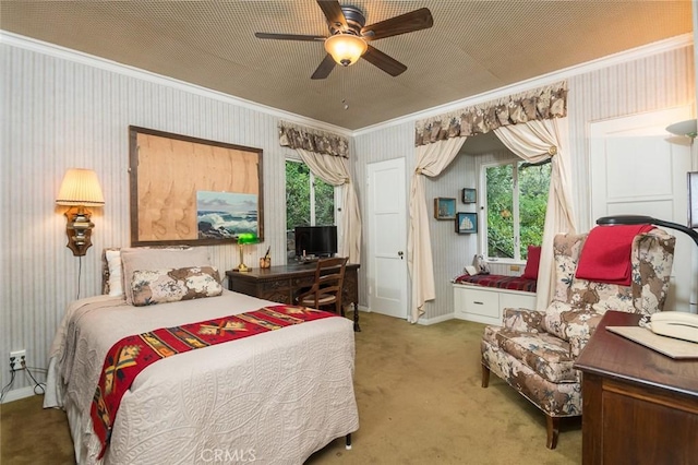 bedroom with multiple windows, carpet floors, ornamental molding, and ceiling fan