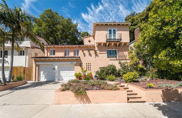 mediterranean / spanish-style house with a garage and a balcony